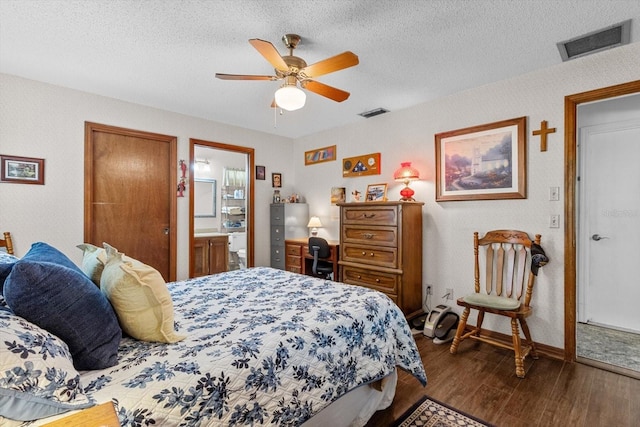 1786 S Border Ave, Inverness, FL 34452 - bedroom featuring dark wood-type flooring, baseboards, a textured ceiling, a ceiling fan, and ensuite bath