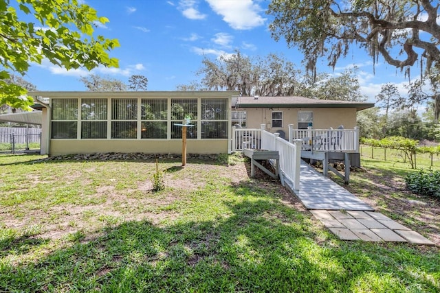 1786 S Border Ave, Inverness, FL 34452 - back of property with a wooden deck and a sunroom