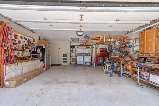 1786 S Border Ave, Inverness, FL 34452 - garage featuring a workshop area, freestanding refrigerator, and washer and dryer