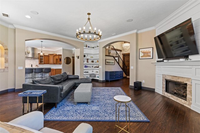 living room with arched walkways, dark wood-style flooring, a chandelier, a fireplace, and baseboards