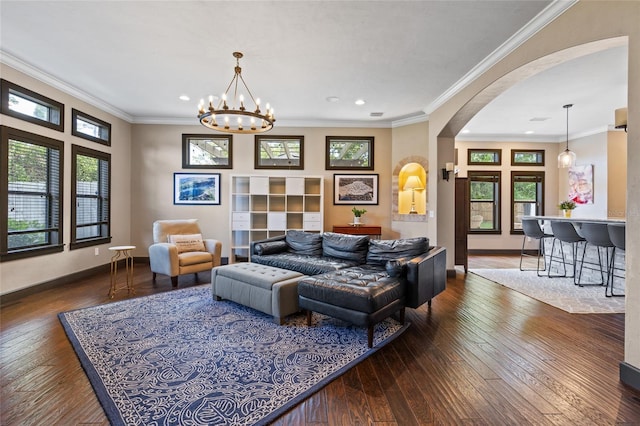 living area featuring arched walkways, hardwood / wood-style flooring, recessed lighting, baseboards, and plenty of natural light