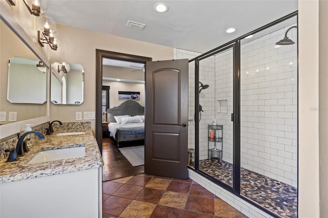 full bath with a stall shower, connected bathroom, double vanity, and recessed lighting