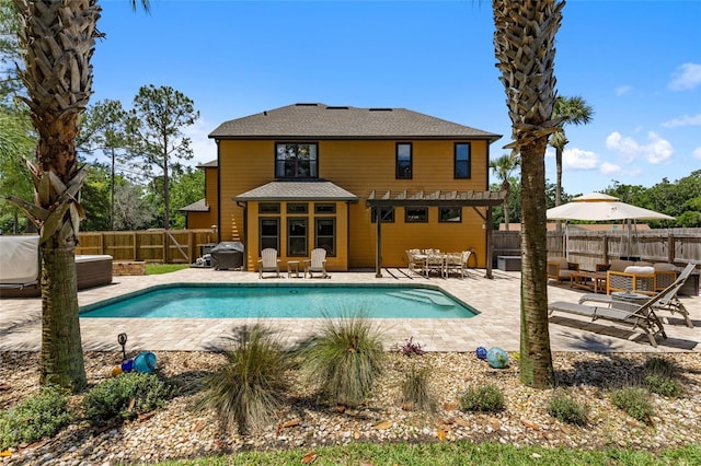 view of swimming pool with a fenced backyard and a patio