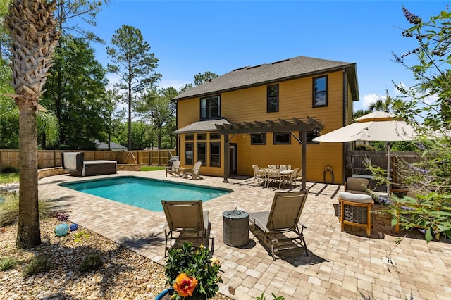 view of swimming pool with a pergola, a hot tub, a fenced backyard, outdoor dining space, and a patio area