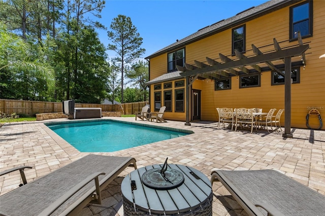 view of pool with outdoor dining space, a fenced backyard, a patio area, and a hot tub