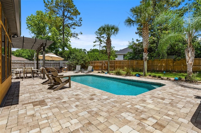 view of swimming pool with a patio, a pergola, outdoor dining area, and a fenced backyard