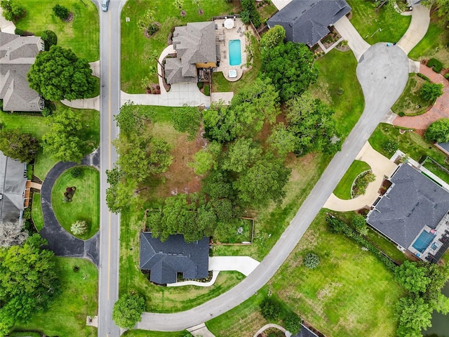 aerial view of property's location featuring a pool and nearby suburban area