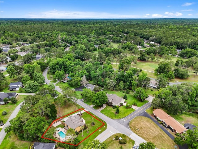 aerial view of property and surrounding area with a heavily wooded area and property boundaries highlighted