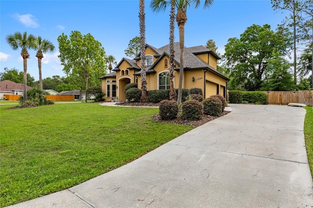 traditional-style house with stucco siding, concrete driveway, a shingled roof, and a garage