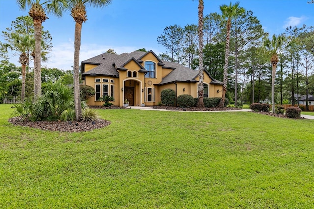 view of front of property with stucco siding and a front lawn