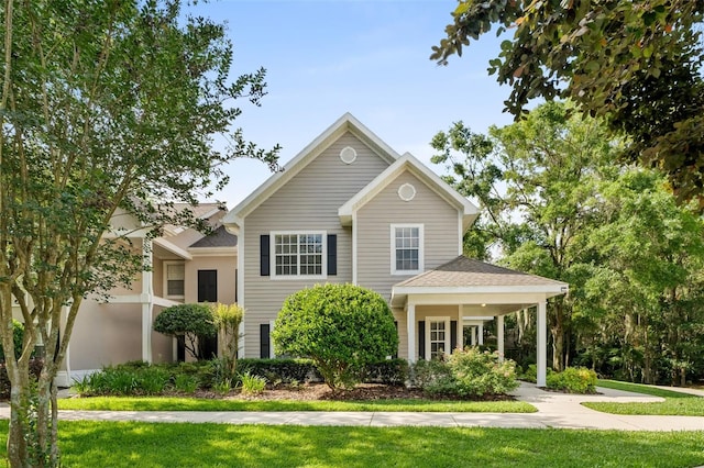 10000 SW 52nd Ave Unit J50, Gainesville, FL 32608 - view of front of home featuring a front lawn and a shingled roof