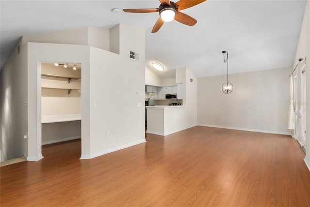 10000 SW 52nd Ave Unit J50, Gainesville, FL 32608 - unfurnished living room with vaulted ceiling, a ceiling fan, light wood-type flooring, and baseboards
