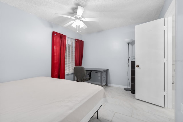 bedroom with light marble finish flooring, a textured ceiling, and a ceiling fan