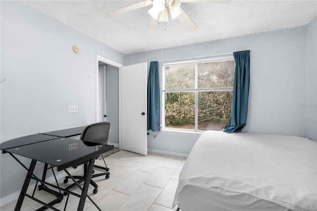 bedroom featuring a textured ceiling, baseboards, and a ceiling fan