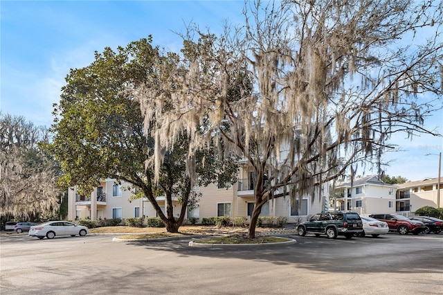 view of property featuring uncovered parking