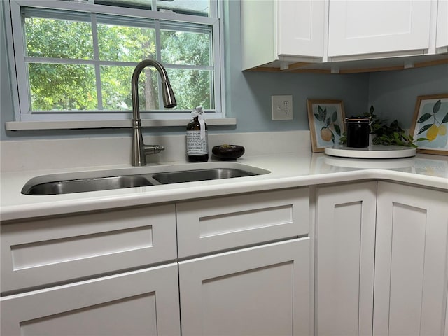 5610 NW 29th Ter, Gainesville, FL 32653 - kitchen featuring white cabinetry and light countertops