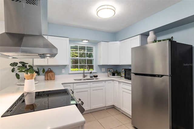 5610 NW 29th Ter, Gainesville, FL 32653 - kitchen featuring freestanding refrigerator, ventilation hood, white cabinets, light countertops, and electric range