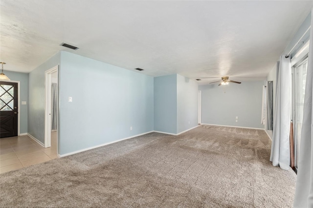 5610 NW 29th Ter, Gainesville, FL 32653 - tiled empty room featuring carpet and a ceiling fan