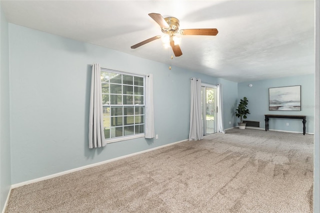 5610 NW 29th Ter, Gainesville, FL 32653 - unfurnished living room with carpet floors and a ceiling fan