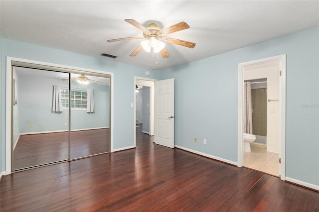 5610 NW 29th Ter, Gainesville, FL 32653 - unfurnished bedroom featuring a closet, wood finished floors, ceiling fan, and ensuite bath
