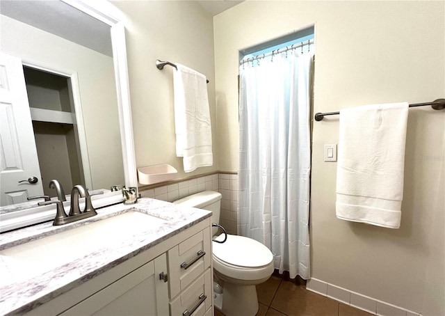 5610 NW 29th Ter, Gainesville, FL 32653 - bathroom with tile patterned floors, vanity, tile walls, and curtained shower