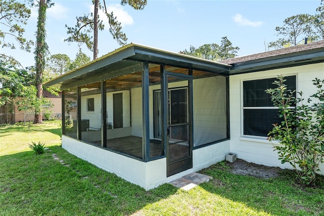 5610 NW 29th Ter, Gainesville, FL 32653 - back of house featuring a sunroom and a yard