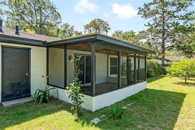 5610 NW 29th Ter, Gainesville, FL 32653 - view of property exterior featuring a sunroom and a lawn