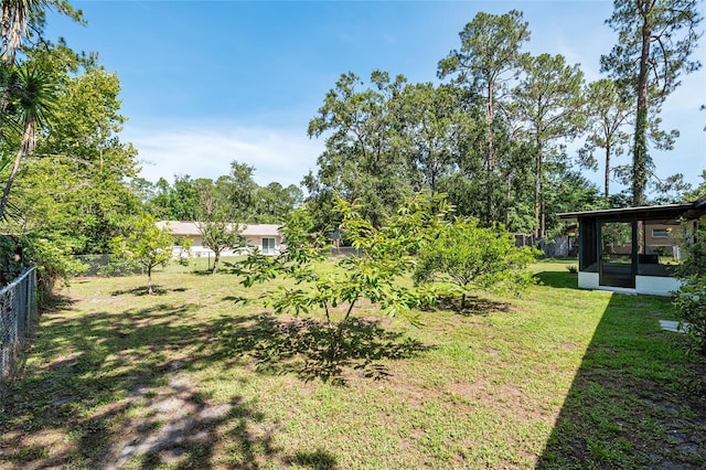 5610 NW 29th Ter, Gainesville, FL 32653 - fenced backyard with a sunroom and view of scattered trees