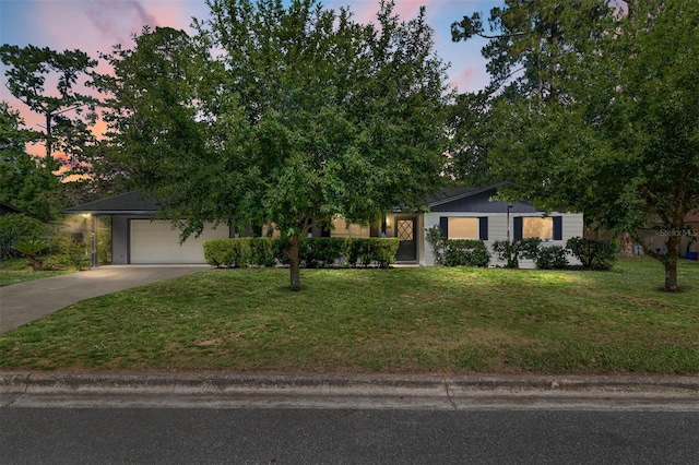 5610 NW 29th Ter, Gainesville, FL 32653 - view of front of house featuring driveway, a lawn, and an attached garage