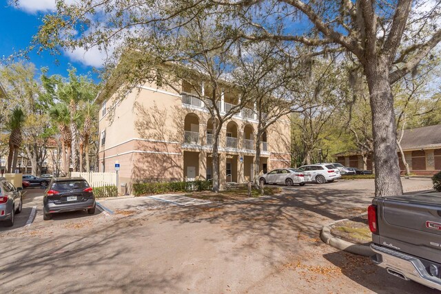 9119 SW 52nd Ave Unit C301, Gainesville, FL 32608 - view of front of home with uncovered parking and a balcony
