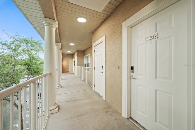 9119 SW 52nd Ave Unit C301, Gainesville, FL 32608 - doorway to property with stucco siding and a balcony