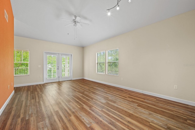 9119 SW 52nd Ave Unit C301, Gainesville, FL 32608 - empty room with ceiling fan, wood finished floors, and baseboards