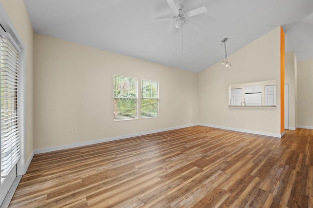 9119 SW 52nd Ave Unit C301, Gainesville, FL 32608 - spare room with vaulted ceiling, wood finished floors, a ceiling fan, and baseboards