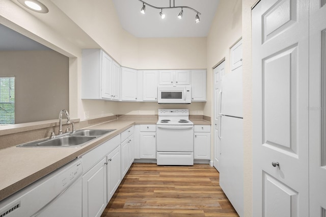 9119 SW 52nd Ave Unit C301, Gainesville, FL 32608 - kitchen featuring white appliances, a sink, white cabinetry, and light wood-style flooring