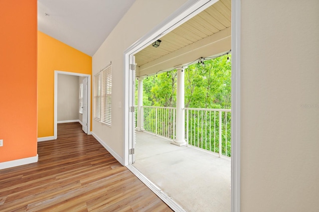 9119 SW 52nd Ave Unit C301, Gainesville, FL 32608 - corridor with baseboards, wood finished floors, and lofted ceiling