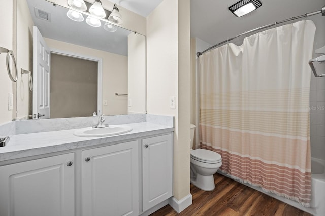 9119 SW 52nd Ave Unit C301, Gainesville, FL 32608 - full bath featuring wood finished floors, toilet, vanity, and shower / bathtub combination with curtain