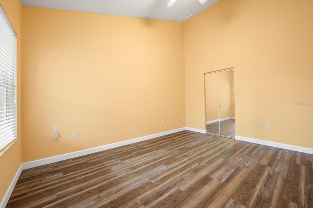 9119 SW 52nd Ave Unit C301, Gainesville, FL 32608 - unfurnished room featuring dark wood-type flooring, a ceiling fan, and baseboards