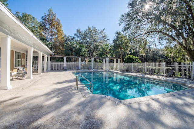 9119 SW 52nd Ave Unit C301, Gainesville, FL 32608 - view of pool featuring a patio area and view of wooded area