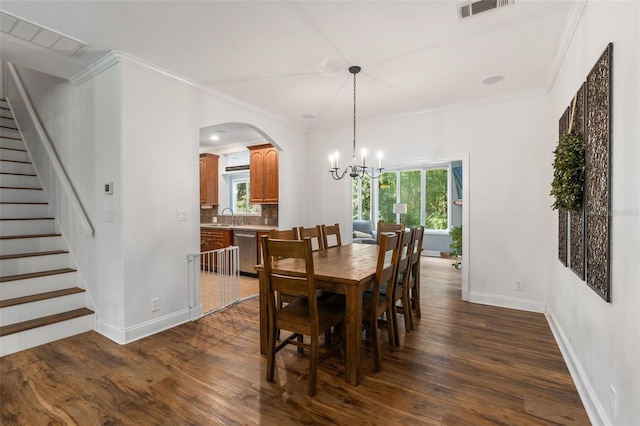 14204 SW 70th St, Archer, FL 32618 - dining area featuring a chandelier, baseboards, dark wood-style flooring, stairway, and crown molding