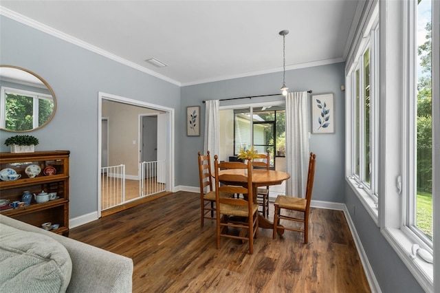 14204 SW 70th St, Archer, FL 32618 - dining room with dark wood-style flooring, crown molding, and baseboards