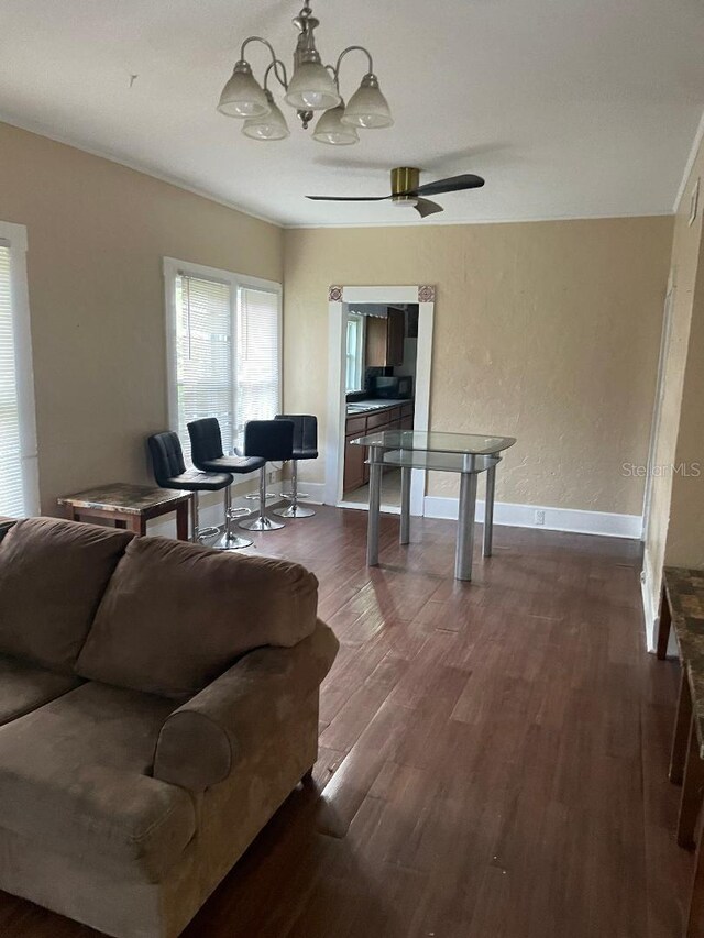 31 NW 4th St, Williston, FL 32696 - living area featuring dark wood-type flooring, a chandelier, and baseboards