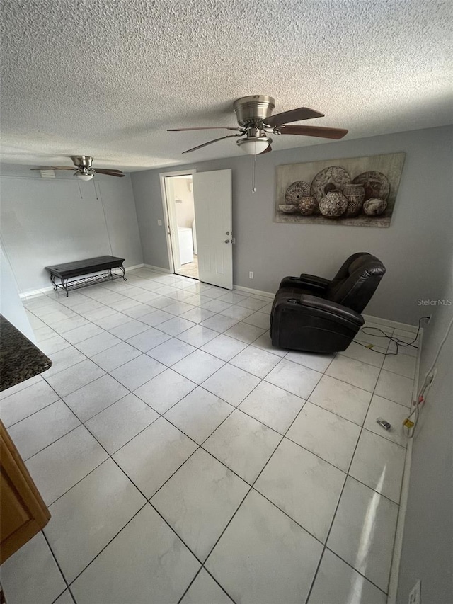 6019 W Fern St, Tampa, FL 33634 - living room featuring light tile patterned floors, a ceiling fan, a textured ceiling, and baseboards