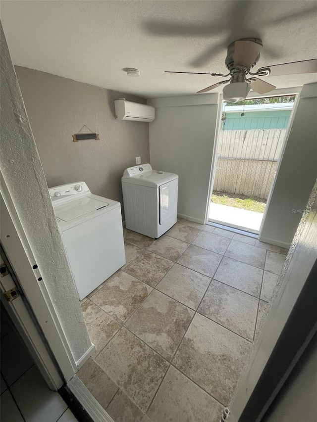 6019 W Fern St, Tampa, FL 33634 - washroom featuring washing machine and dryer, a wall unit AC, ceiling fan, a textured ceiling, and a textured wall