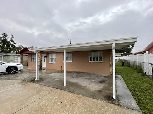 6019 W Fern St, Tampa, FL 33634 - view of home's exterior featuring fence and stucco siding