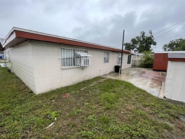 6019 W Fern St, Tampa, FL 33634 - back of house featuring a patio and concrete block siding