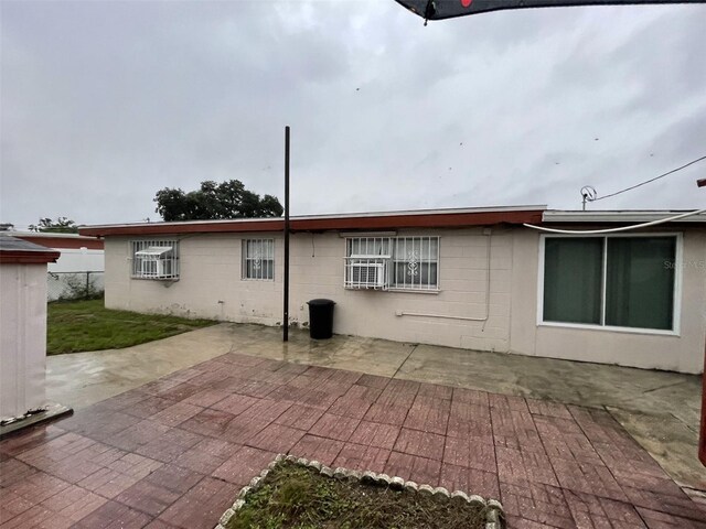 6019 W Fern St, Tampa, FL 33634 - back of property with a patio and concrete block siding