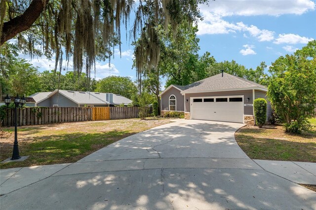 3664 NW 55th Ln, Gainesville, FL 32653 - single story home with concrete driveway, an attached garage, stone siding, and roof with shingles
