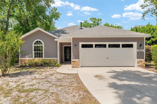 3664 NW 55th Ln, Gainesville, FL 32653 - ranch-style home with stone siding, concrete driveway, a garage, and a shingled roof