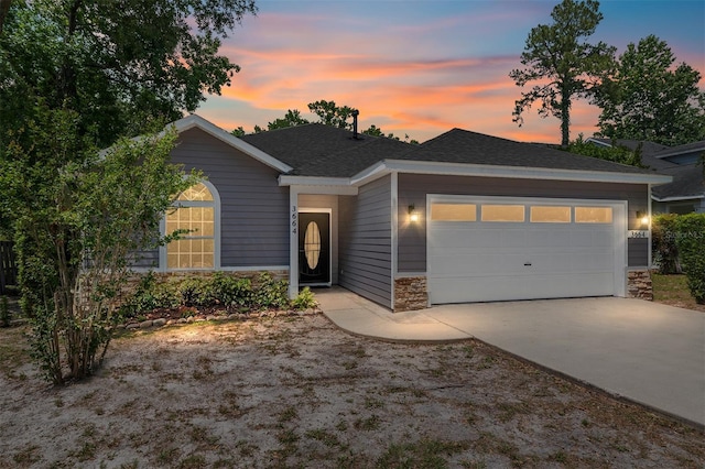 3664 NW 55th Ln, Gainesville, FL 32653 - single story home featuring stone siding, a garage, and driveway