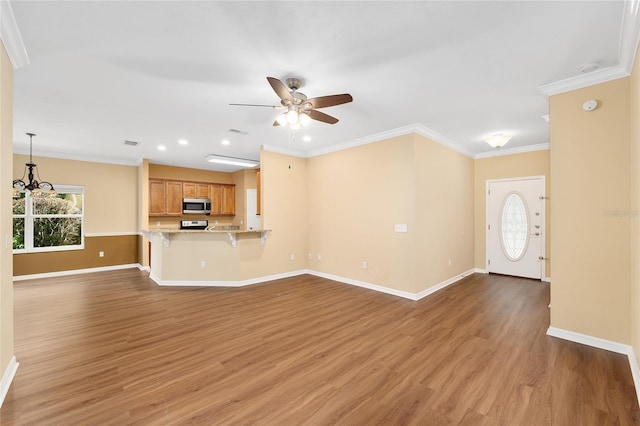 3664 NW 55th Ln, Gainesville, FL 32653 - unfurnished living room with ceiling fan, light wood-style floors, baseboards, recessed lighting, and a chandelier